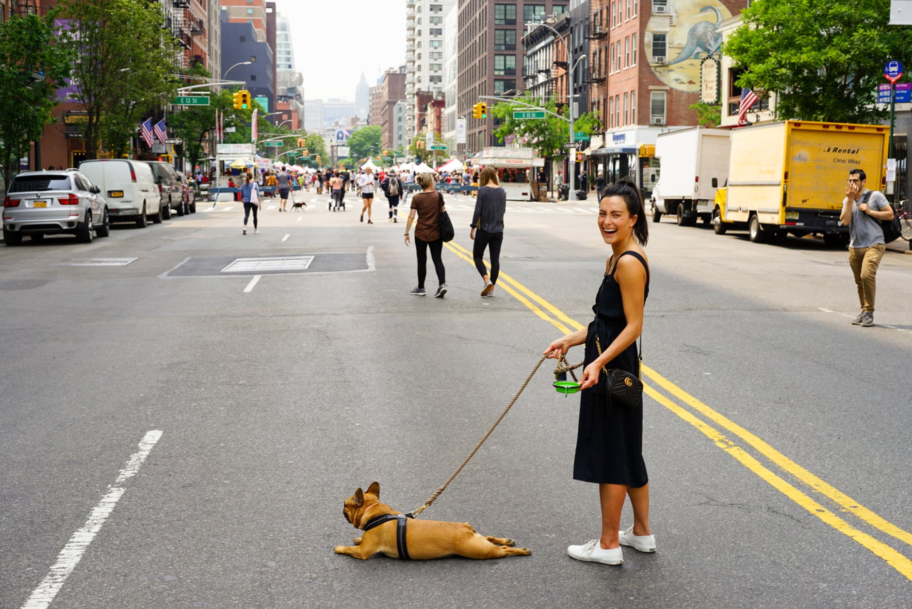 woman with dog at the middle of the street
